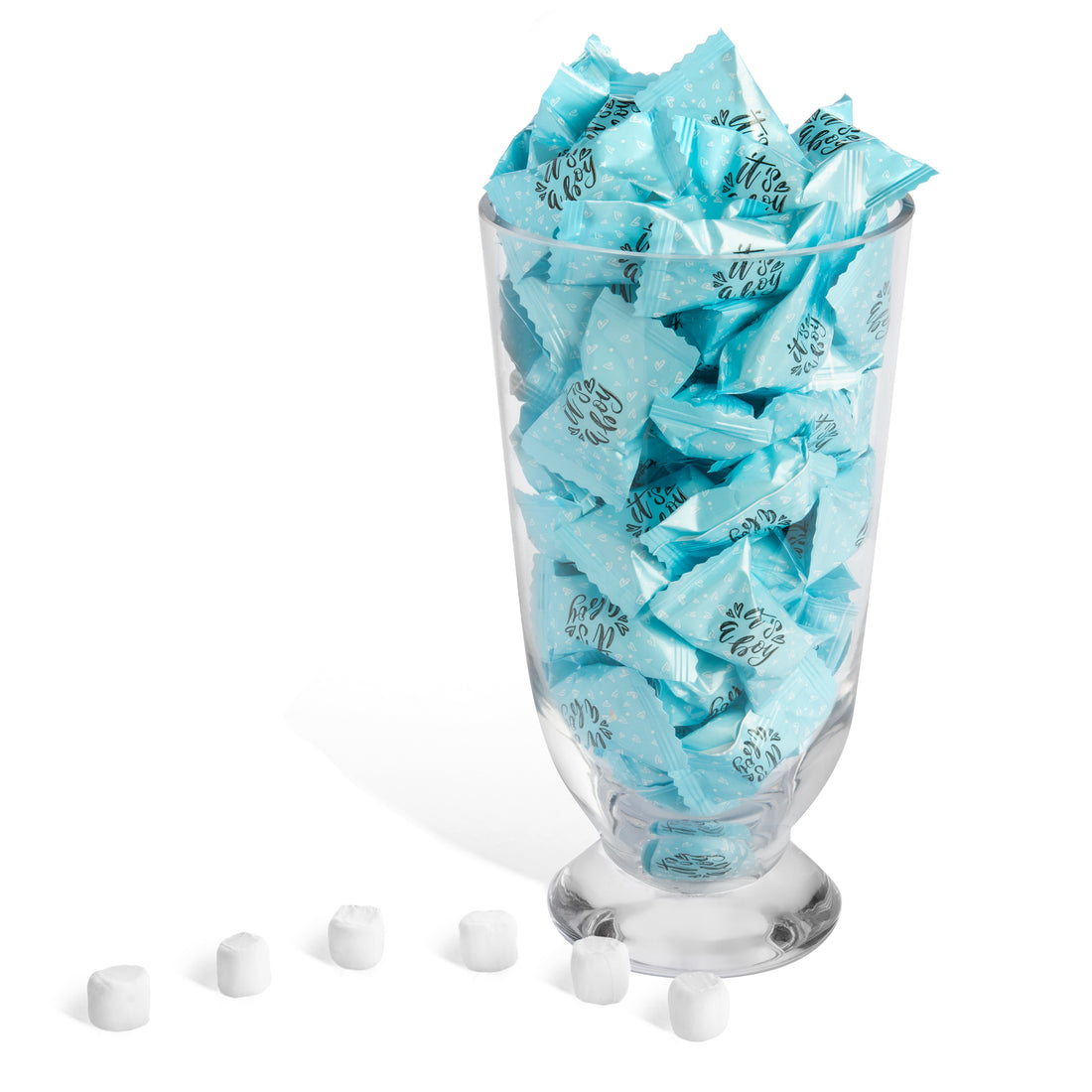 Glass filled with blue wrapped candies on a white background